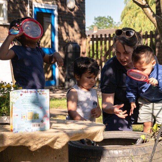 Elmhurst school children exploring outdoors with teacher